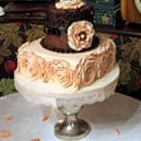 White three tiered wedding cake adorned with flowers
