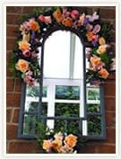 Mirror decorated with selection of flowers